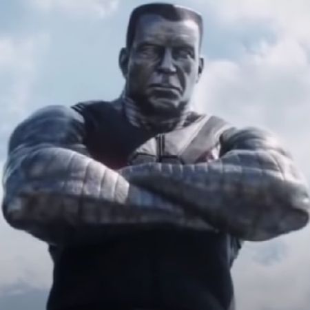 Colossus is standing with his arms folded.